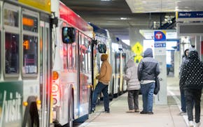 Commuters wait in line to board a bus Tuesday, Feb. 13, 2024 at the Mall of America Transit Station in Bloomington.