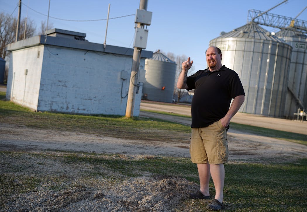 Utica City Councilman Robbie Floerke, pictured here next to his town’s main well house, said the town doesn’t want to spend money to drill a new well but has no choice given the nitrate contamination.