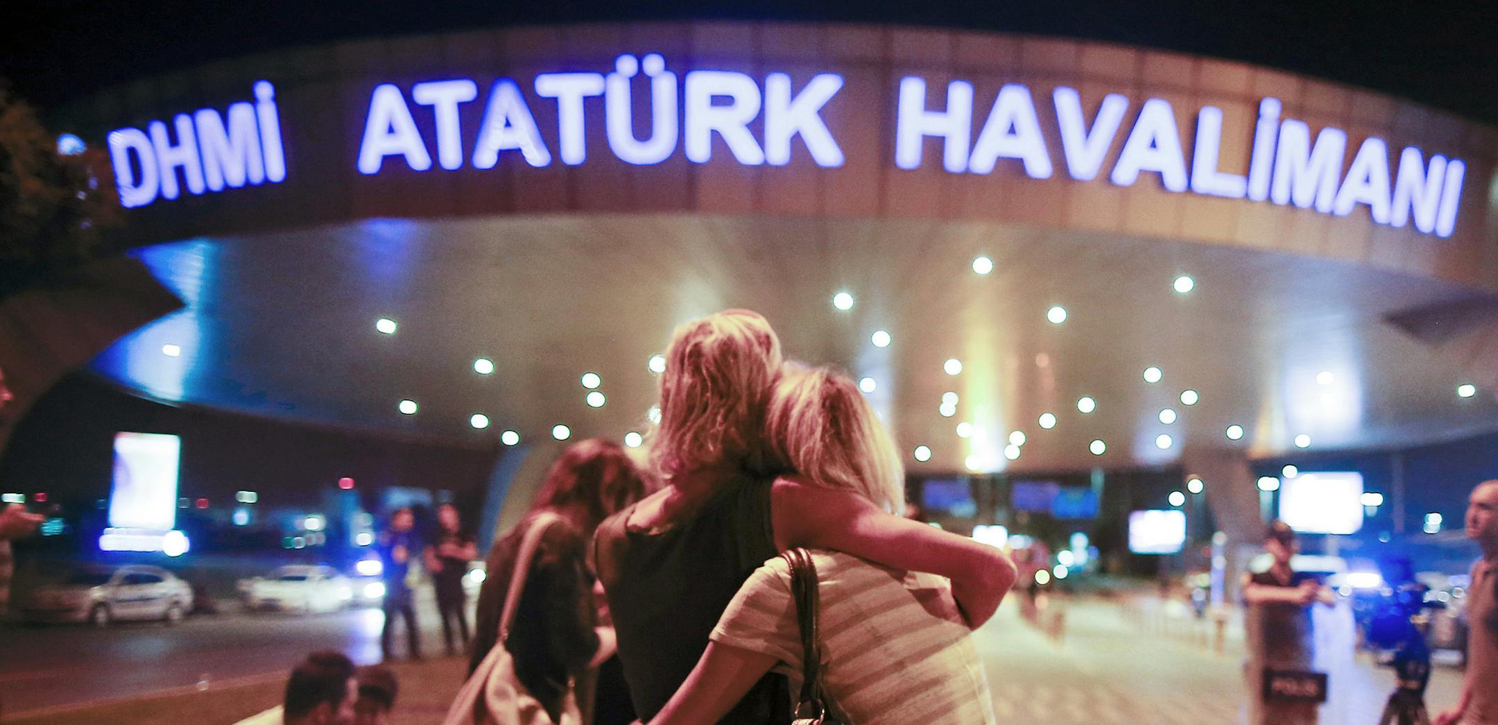 Passengers embrace each other at the entrance to Istanbul's Ataturk airport, early Wednesday, June 29, 2016 following their evacuation after a blast. Suspected Islamic State group extremists have hit the international terminal of Istanbul's Ataturk airport, killing dozens of people and wounding many others, Turkish officials said Tuesday. Turkish authorities have banned distribution of images relating to the Ataturk airport attack within Turkey. (AP Photo/Emrah Gurel) TURKEY OUT ORG XMIT: MIN201