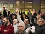 Those who approved a motion to refuse refugee resettlement raised their hands in the overcapacity crowd in attendance.] Beltrami County is the latest 