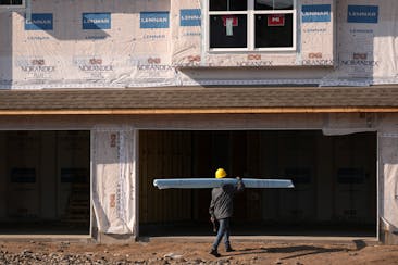 Construction and HVAC crews work to complete units at the Lennar at Lynwood housing development Tuesday, May 14, 2024 in Ramsey, Minn.  ] ANTHONY SOUF