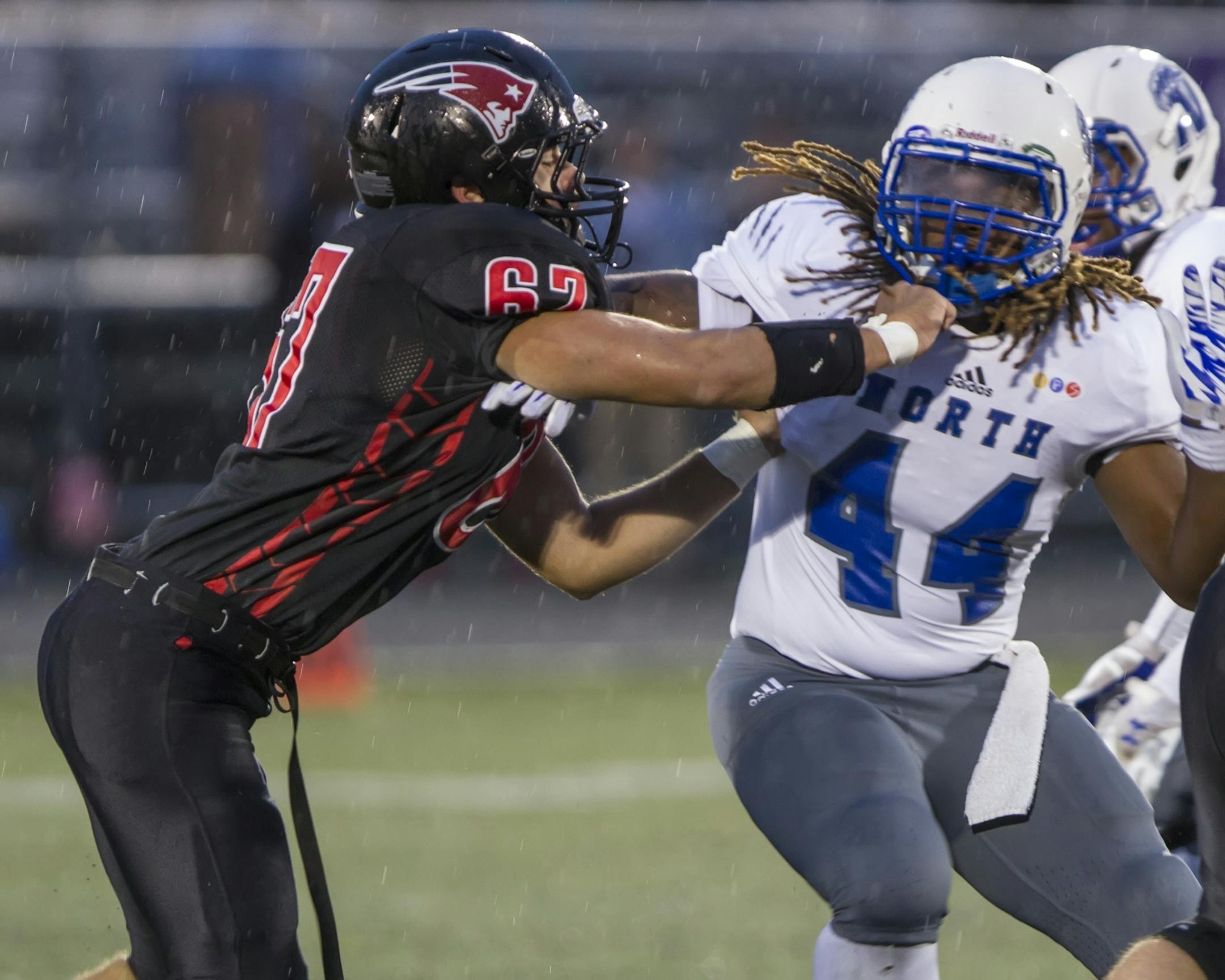 Minneapolis North 44 Kori Randle tries to get around St. Paul Central 67 Ethan Levin as the St. Paul Central Minutemen host the Minneapolis North Polars on September 18, 2015. [Special to Star Tribune Matt Blewett � matt@mattebphoto.com 20041171A SLUG: PREP091915.central
