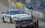 Kevin Harvick waved the checkered flag to celebrate his win after he and Stewart-Haas Racing co-owner Tony Stewart performed dual burnouts following a
