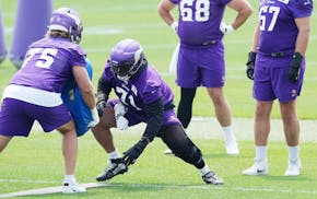 Vikings left tackle Christian Darrisaw (71) participated in two days of this week's minicamp wearing a knee brace.