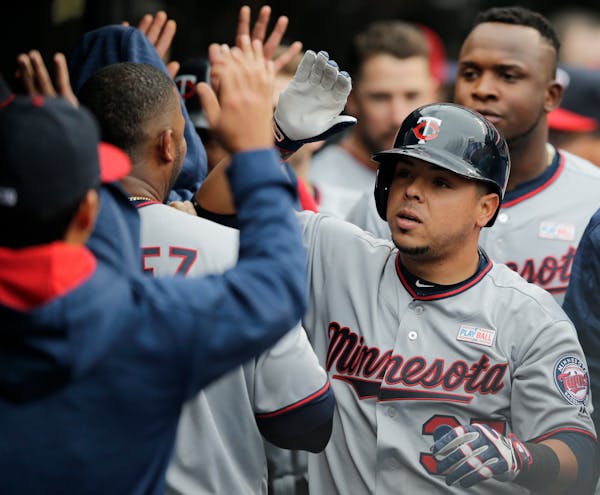 The Twins' Juan Centeno received congratulations from teammates after hitting a two-run homer off Cleveland Indians starting pitcher Corey Kluber in t