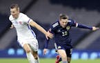 Scotland's Callum McGregor, right, and Slovakia's Jan Gregus battle for the ball during the UEFA Nations League soccer match between Scotland and Slov