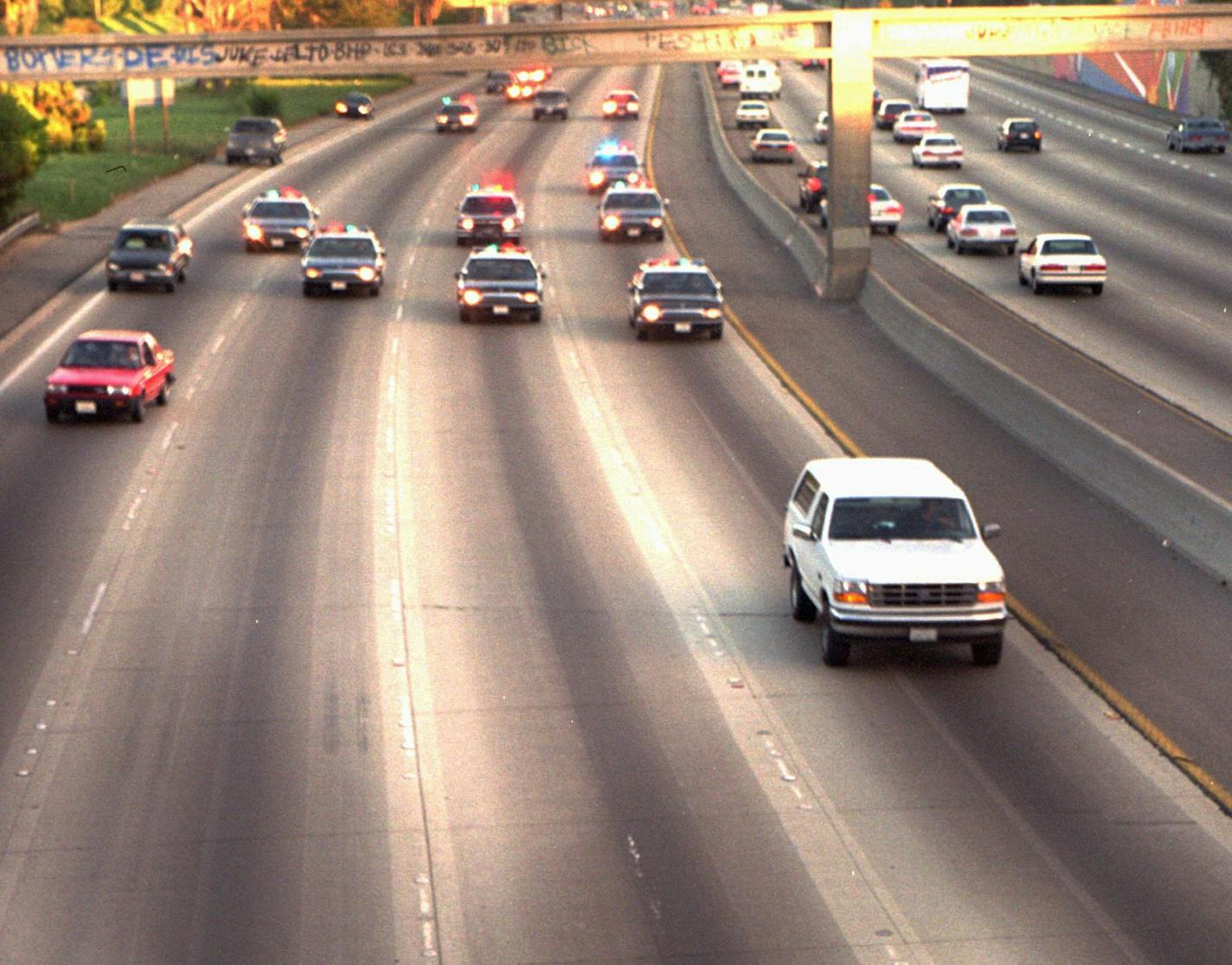 FOR USE AS DESIRED WITH SIMPSON DELIBERATION STORIES--FILE- A white Ford Bronco, driven by Al Cowlings and carrying O.J. Simpson, is trailed by police cars as it travels on a southern California freeway on June 17, 1994, in Los Angeles. Cowlings and Simpson led authorities on a chase after Simpson was charged with two counts of murder in the deaths of his ex-wife and her friend. (AP Photo/Joseph Villarin)