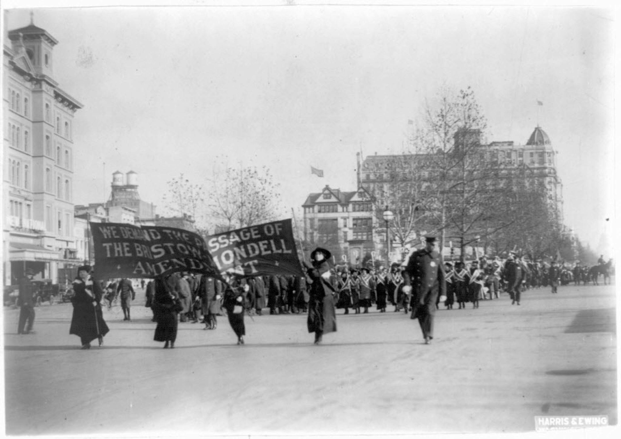 In this photo provided by the Library of Congress, taken in 1913, four women march ahead of large procession with the banner "We demand the passage of the Bristow-Mondell amendment" at the woman suffrage parade in Washington.