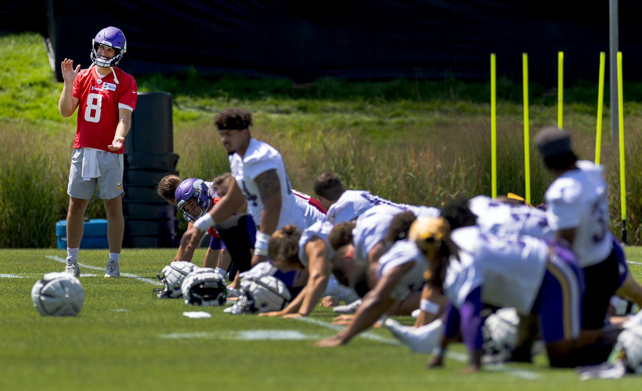 Minnesota Vikings quarterback Kirk Cousins (8) and teammates stretch during practice.