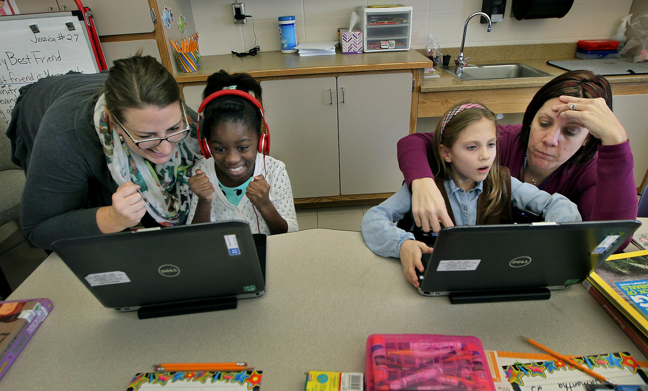 Program Coordinator Cara Rieckenberg, left, with third-grader Arvina Smith, and teacher Jessica Schultz, right with student Samantha "Sam" Thomson, cq, worked on their coding skills during the "Hour of Code" at Robbinsdale's School of Engineering and Arts, Monday, December 7, 2015 in Robbinsdale, MN. ] (ELIZABETH FLORES/STAR TRIBUNE) ELIZABETH FLORES • eflores@startribune.com