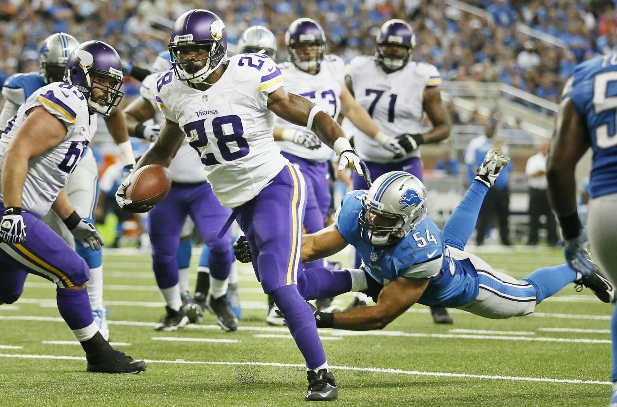Minnesota Vikings running back Adrian Peterson (28), broke the tackle of Detroit linebacker DeAndre Levy (54) for a third quarter touchdown during NFL action at Ford Field between the MInnesota Vikings and Detroit Lions Sunday September 8, 2013 in Detroit, MI. Detroit beat Minnesota 34-24.