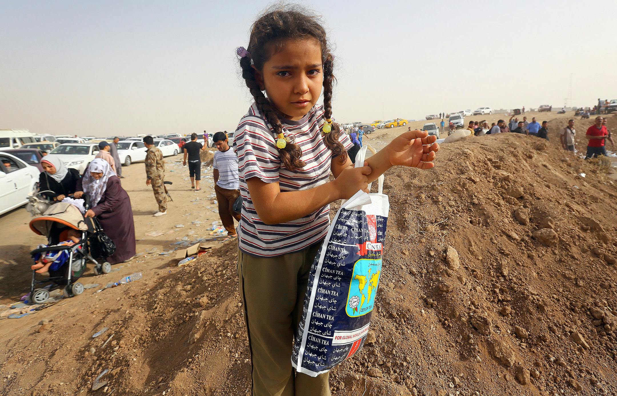Refugees fleeing from Mosul head to the self-ruled northern Kurdish region in Irbil, Iraq, 217 miles north of Baghdad, Thursday, June 12, 2014.