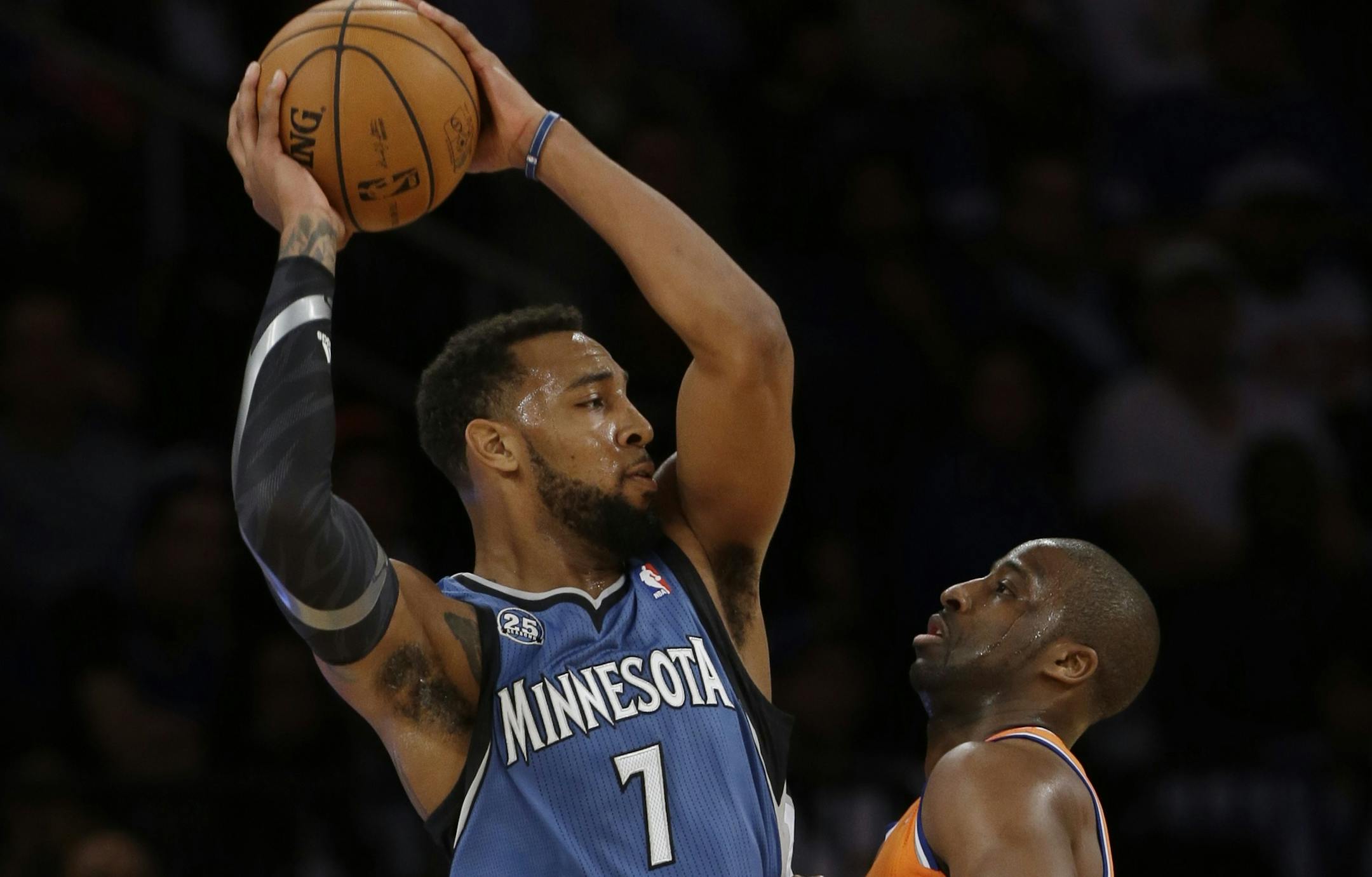 Minnesota Timberwolves' Derrick Williams (7) protects the ball from New York Knicks' Raymond Felton, right, during the first half of an NBA basketball game Sunday, Nov. 3, 2013, in New York. (AP Photo/Frank Franklin II)