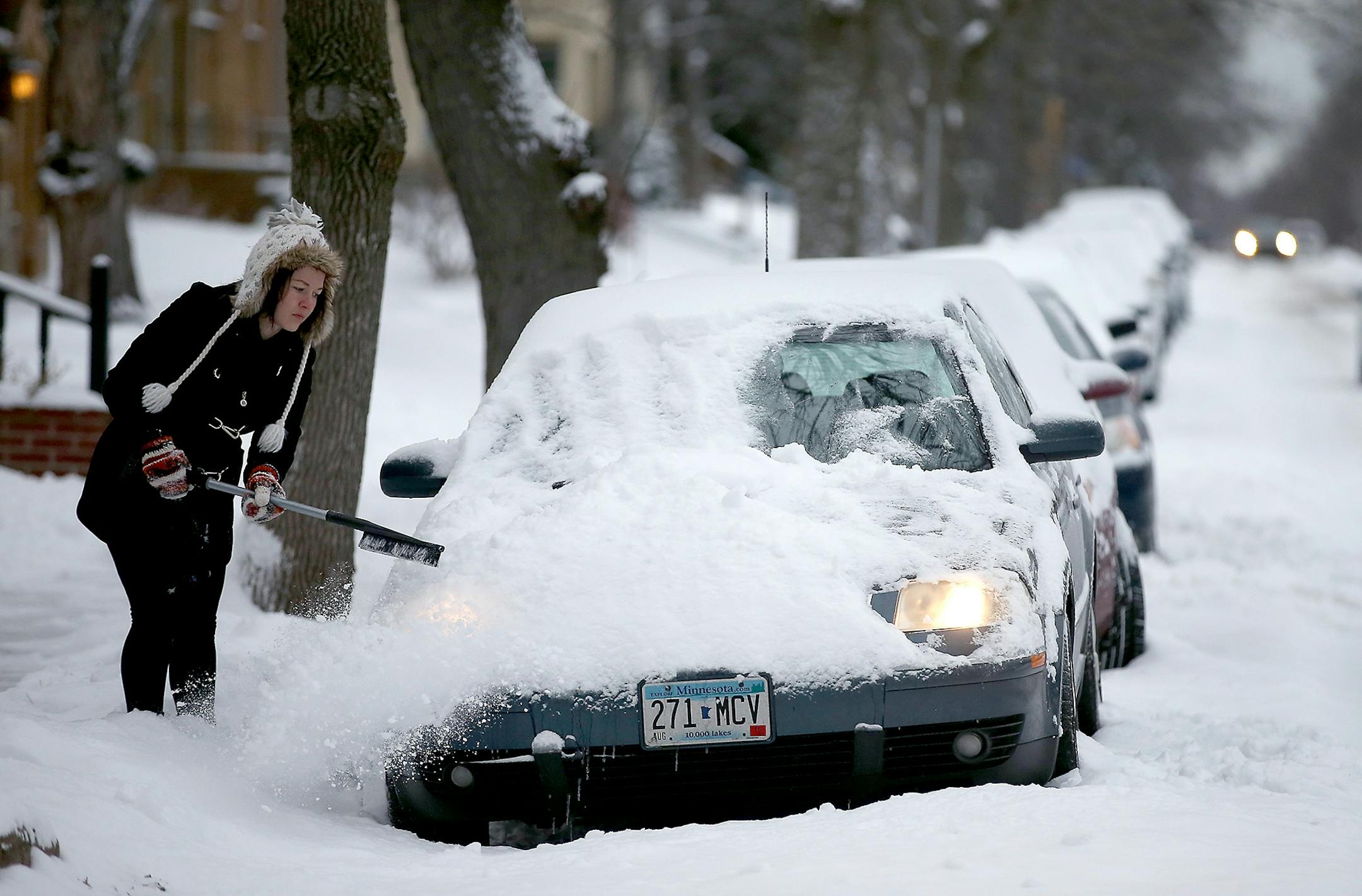 "It (the snow) is so beautiful," said Amber Dao as she cleared her car of the white fluff, Tuesday, December 29, 2015 in Minneapolis, MN.