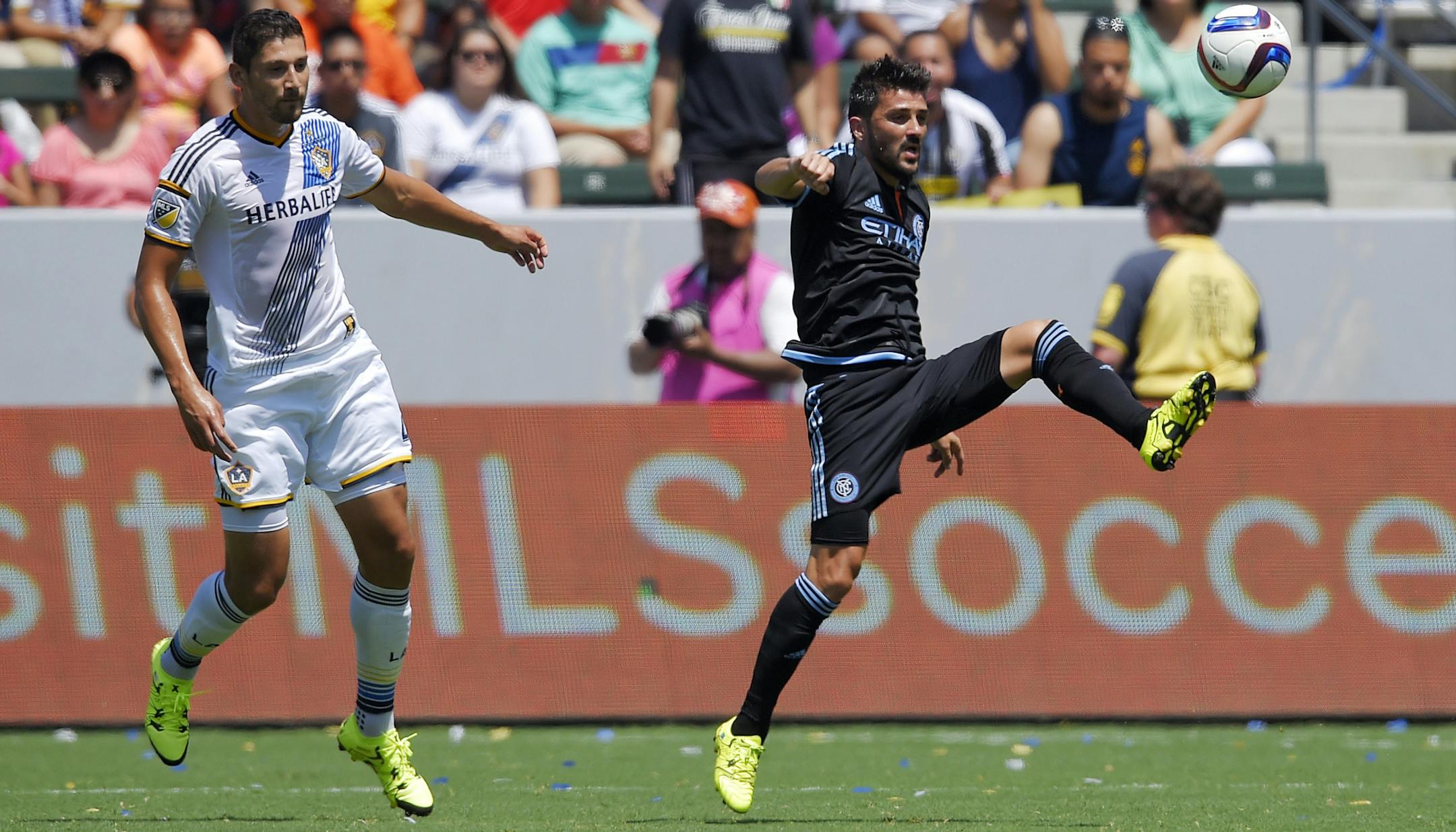 New York City FC forward David Villa, right, of Spain, kicks the ball as Los Angeles Galaxy defender Omar Gonzalez watches during the first half of an MLS soccer match, Sunday, Aug. 23, 2015, in Carson, Calif. (AP Photo/Mark J. Terrill) ORG XMIT: CAMT123