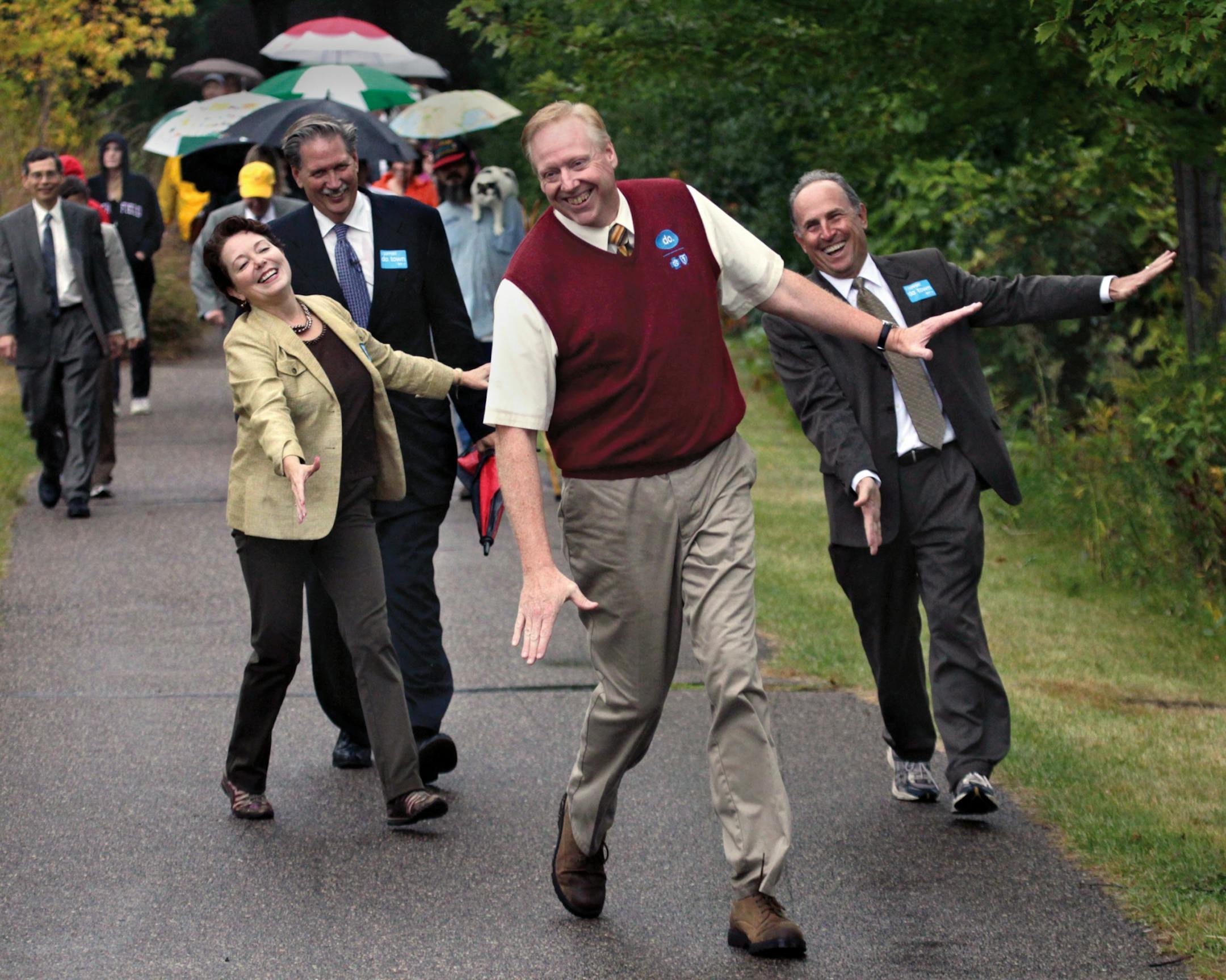 Actor Dexter Warren of the "do-groove" commercials led mayors Debbie Goettel, Jim Hovland and Gene Winstead along the walkway around Bloomington Lake.