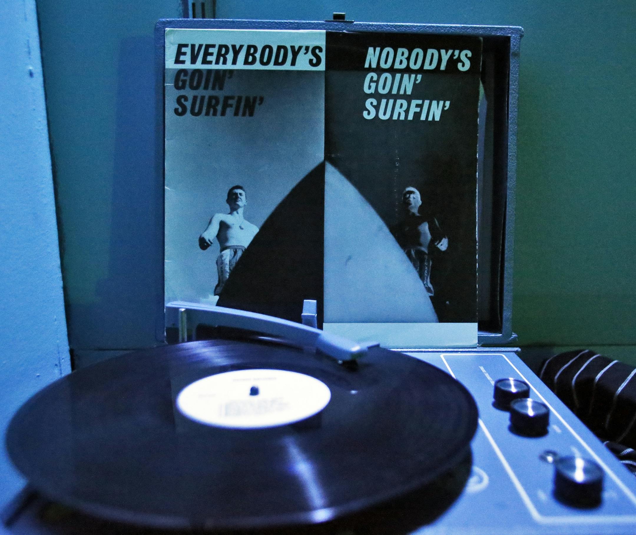 A group works on the various clues presented to them in an effort to find passage out of the riddle room. A record player holds some of the clues.