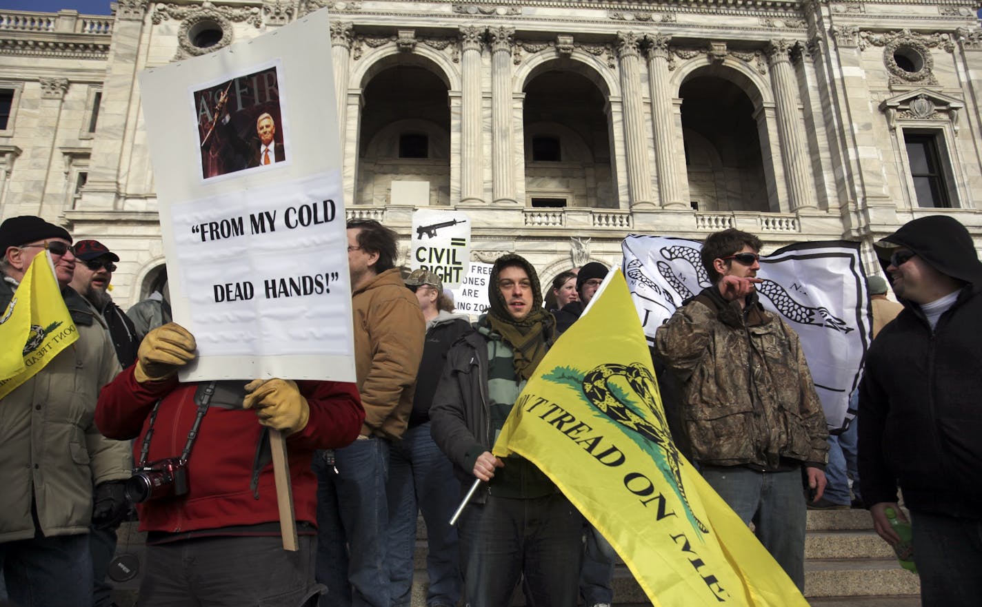 Second amendment supporters stood on the steps during the Capitol rally to protest new gun control legislation Saturday, Jan. 19, 2013, in St. Paul, MN.