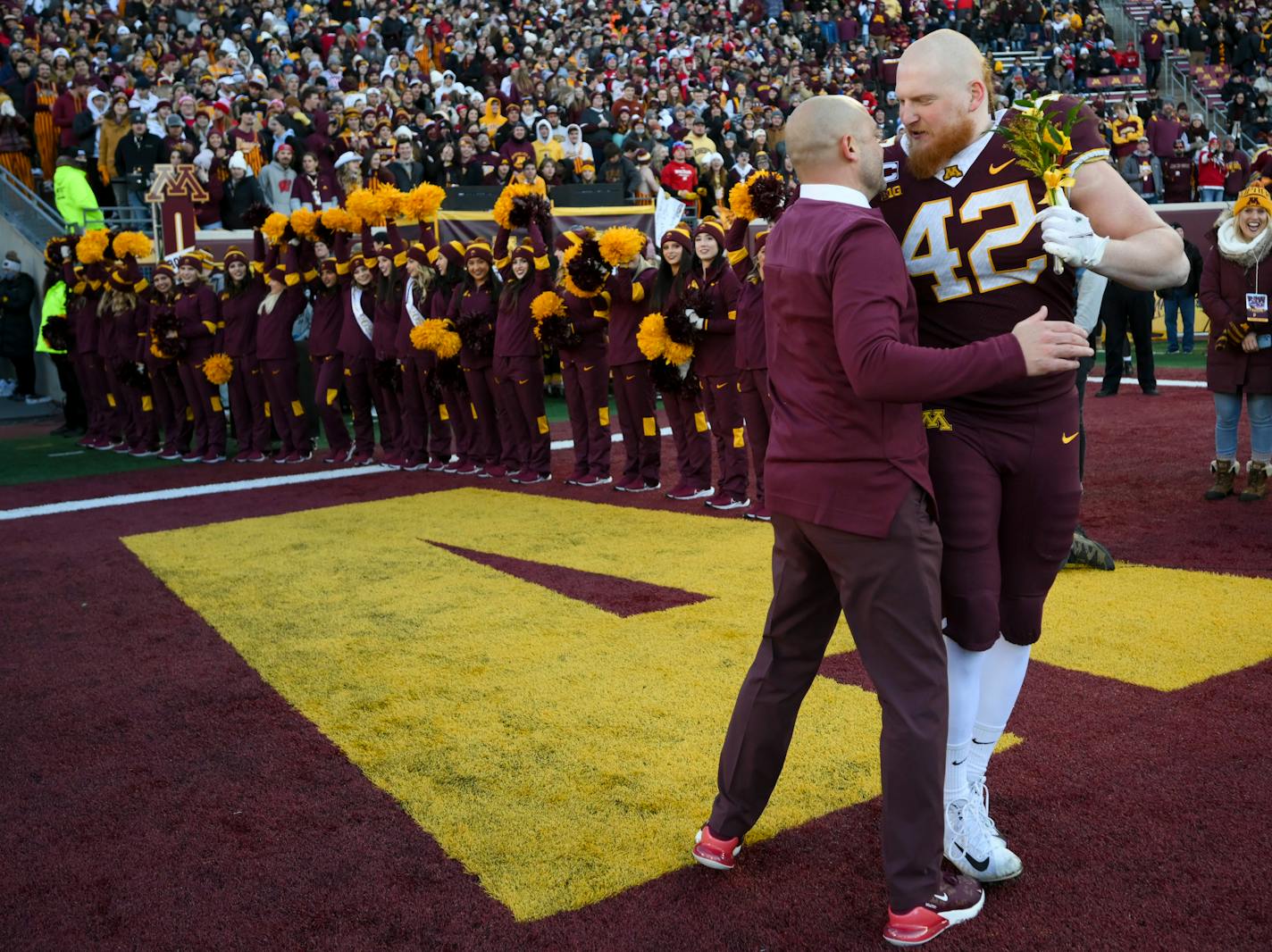 Minnesota Gophers tight end Ko Kieft (42) embraces head coach P.J. Fleck during a senior day ceremony before the start of an NCAA football game between the Gophers and the Wisconsin Badgers Saturday, Nov. 27, 2021 at Huntington Bank Stadium in Minneapolis, Minn. Minnesota defeated Wisconsin 23-13. ] AARON LAVINSKY • aaron.lavinsky@startribune.com