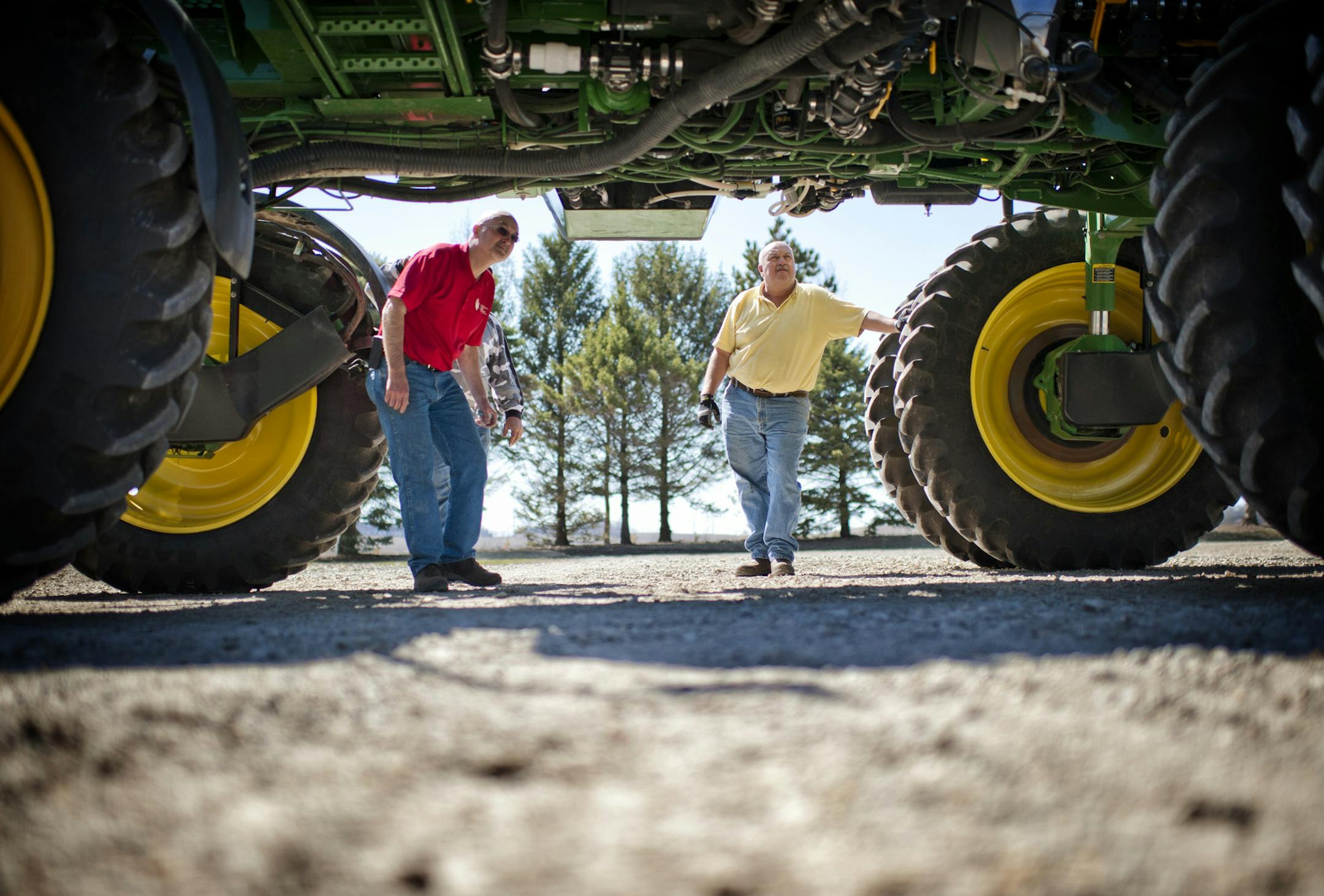 If the weather holds Jerry Demmer, left, expects to start planting his corn and soybean fields this Monday. He was helping his brother Brian get a tractor and planter ready to go. Friday, April 26, 2013 ] GLEN STUBBE * gstubbe@startribune.com EDS, Jerry is wearing red, his brother yellow