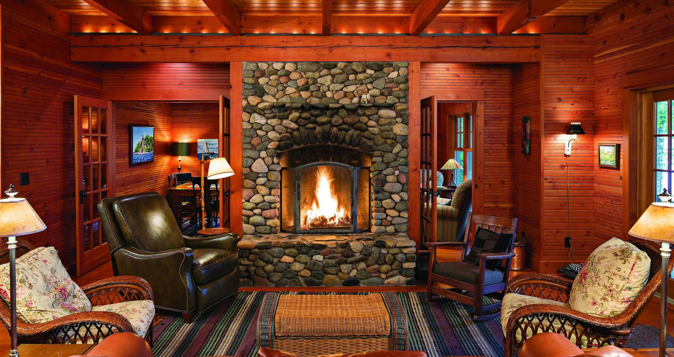 Cabins: Fieldstone fireplace and exposed fir beams are focal points in the living room fo a cabin on Madeline Island designed by Dale Mulfinger