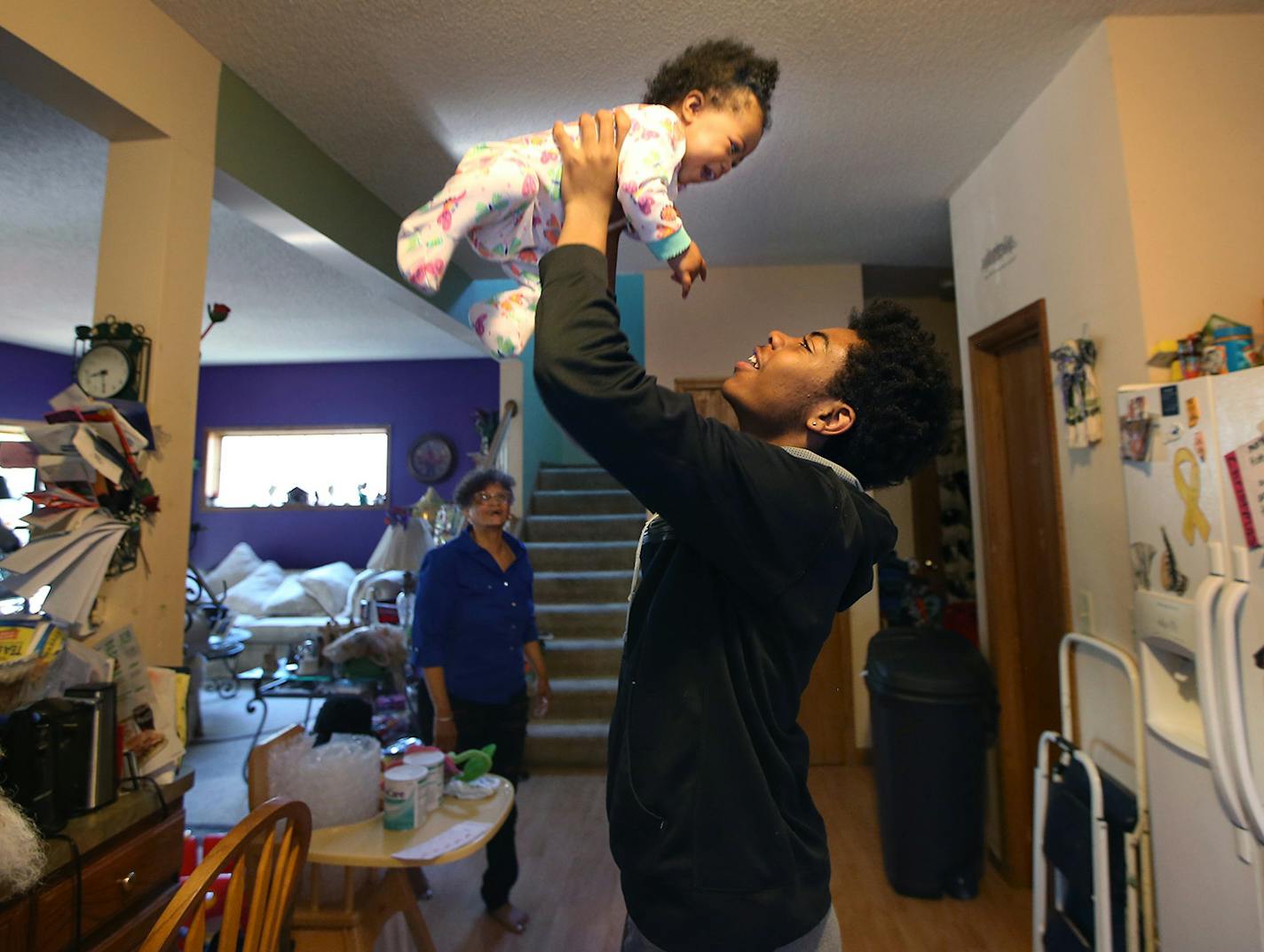 Emmanuel Turner played with his 9-month-old relative McKenzie, cq, before his foster mother Mary Ann Turner gave him a ride to school, Monday, May 16, 2016 in Minneapolis, MN. Mary Ann Turner is a foster parent who adopted Emmanuel, now 15 years old, who has fetal alcohol spectrum disorder (FASD), as an infant. Turner says she received no training for how to deal with his disability, including hyperactivity. Now, Turner is an outspoken advocate for foster parents and testified in favor of a bill