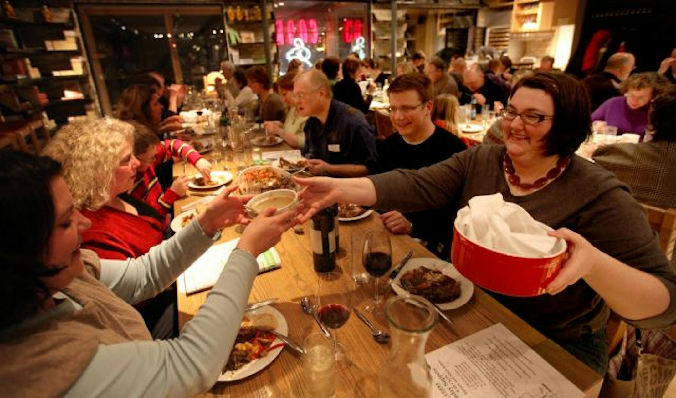 St. Paulites Stephanie Stuart, left, and Gina Reiter, right, at a recent family-style dinner — coq au vin and roasted vegetables — at Cooks of Crocus Hill.