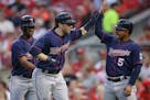 The Twins' Brian Dozier, center, celebrated with Eduardo Escobar (5) and Danny Santana, left, after hitting a three-run homer in the fourth inning Mon