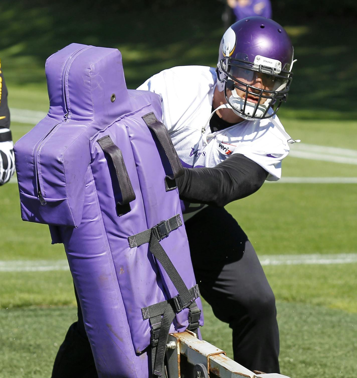 Minnesota Vikings defensive end Brian Robison hits a tackling dummy during practice at Winter Park in Eden Prairie, Minn., Wednesday, Oct. 9, 2013. Robison signed a four-year deal to remain with the team that drafted him. (AP Photo/Ann Heisenfelt)