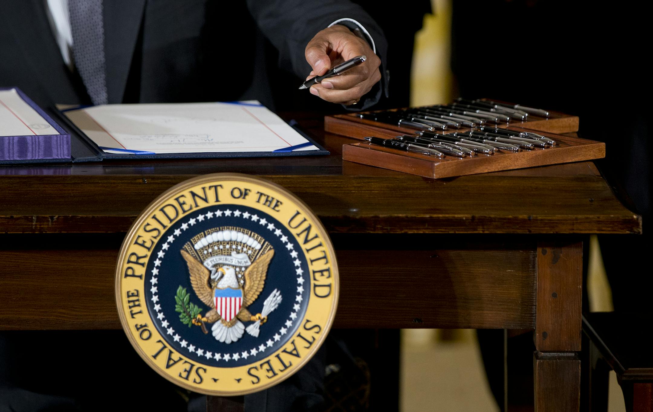President Barack Obama signs H.R. 2146 Defending Public Safety Employeesí Retirement Act and H.R. 1295 Trade Preferences Extension Act of 2015, Monday, June 29, 2015, in the East Room of the White House in Washington. The president signed into law two hard-fought bills giving him greater authority to negotiate international trade deals and providing aid to workers whose jobs are displaced by such pacts (AP Photo/Carolyn Kaster) ORG XMIT: MIN2015063012434435