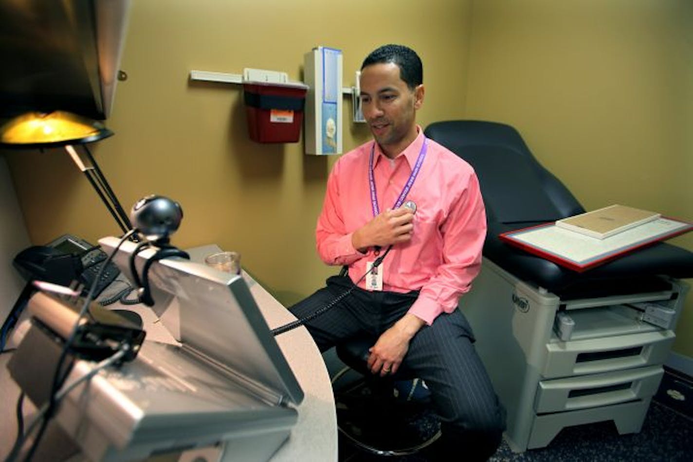 Brooklyn Center High School Principal Bryan Bass tested a stethoscope linked to a computer that will be used at a new school clinic starting next week. A physician will be available to diagnose and monitor chronic illnesses, treat injuries and dispense advice and generic medications, at no cost to employees.