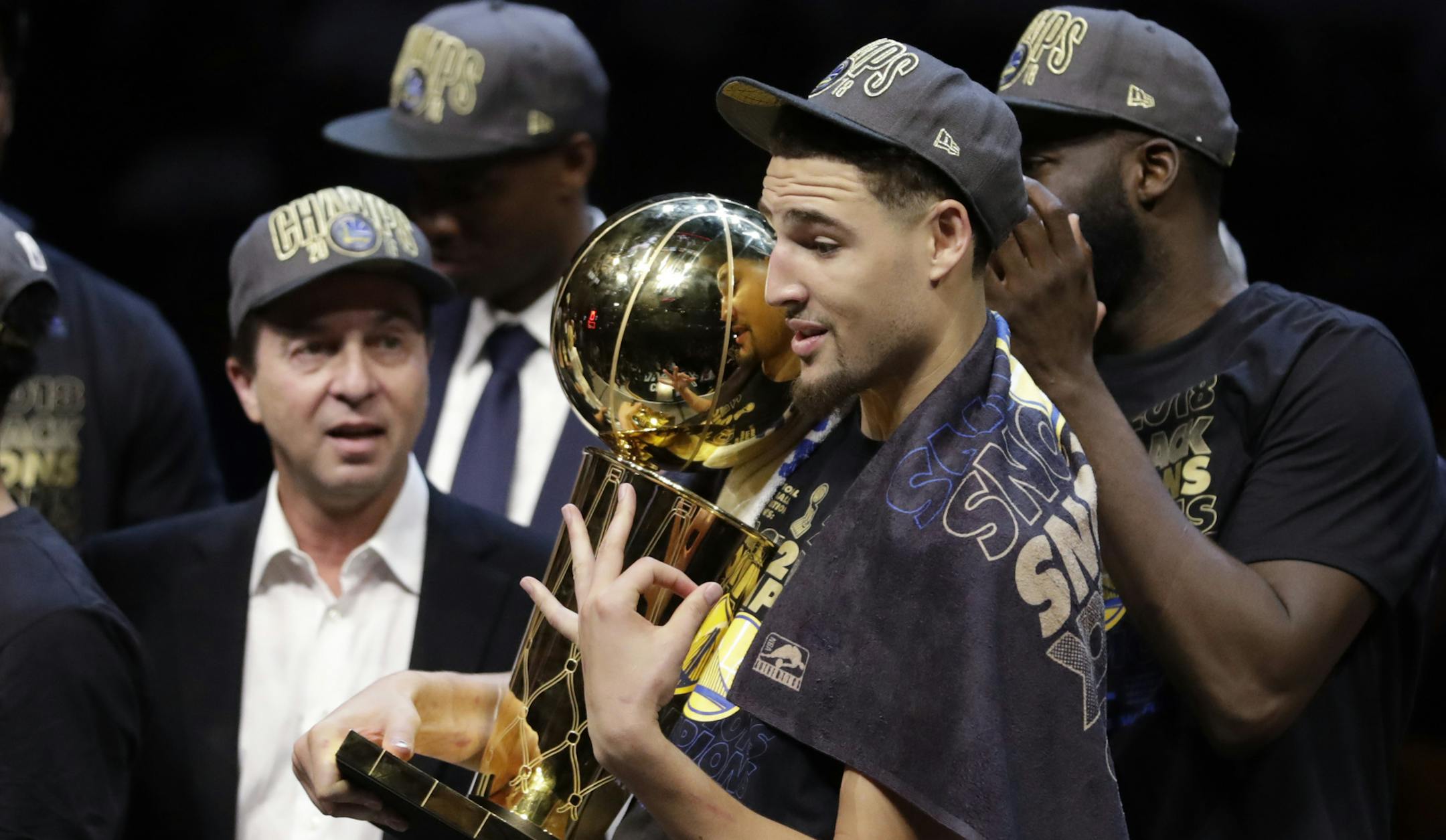 Golden State Warriors' Klay Thompson gestures while holding the trophy after the Warriors defeated the Cleveland Cavaliers 108-85 in Game 4 of basketball's NBA Finals to win the NBA championship, Friday, June 8, 2018, in Cleveland. (AP Photo/Tony Dejak)