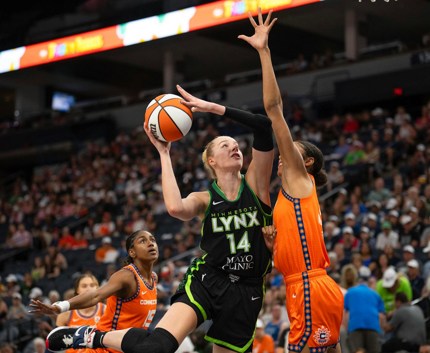 Minnesota Lynx forward Dorka Juhasz (14) shoots while defended by Connecticut Sun forward Olivia Nelson-Ododa (10) during the first half of a WNBA basketball game Thursday, June 22, 2023, Minneapolis. (Jeff Wheeler/Star Tribune via AP)