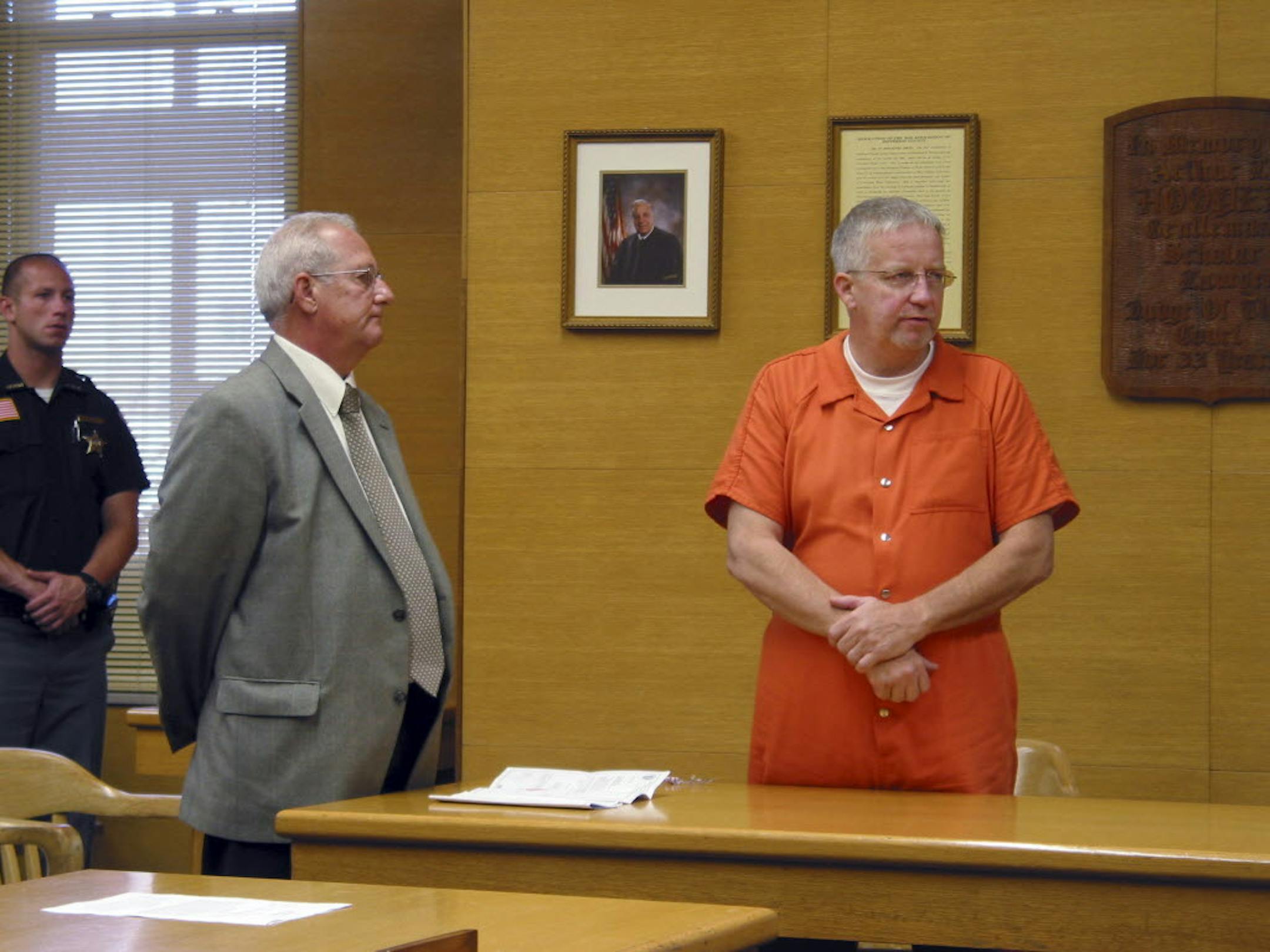 Defense attorney Stephen Lamatrice, left, stands with William Rhinaman during his arraignment Wednesday, Oct. 9, 2013, in Jefferson County Common Pleas Court in Steubenville, Ohio. Rhinaman, the director of technology for the Steubenville City School district, is charged with tampering with evidence, obstructing justice and perjury, in the case involving the rape of a West Virginia girl by two high school football players.