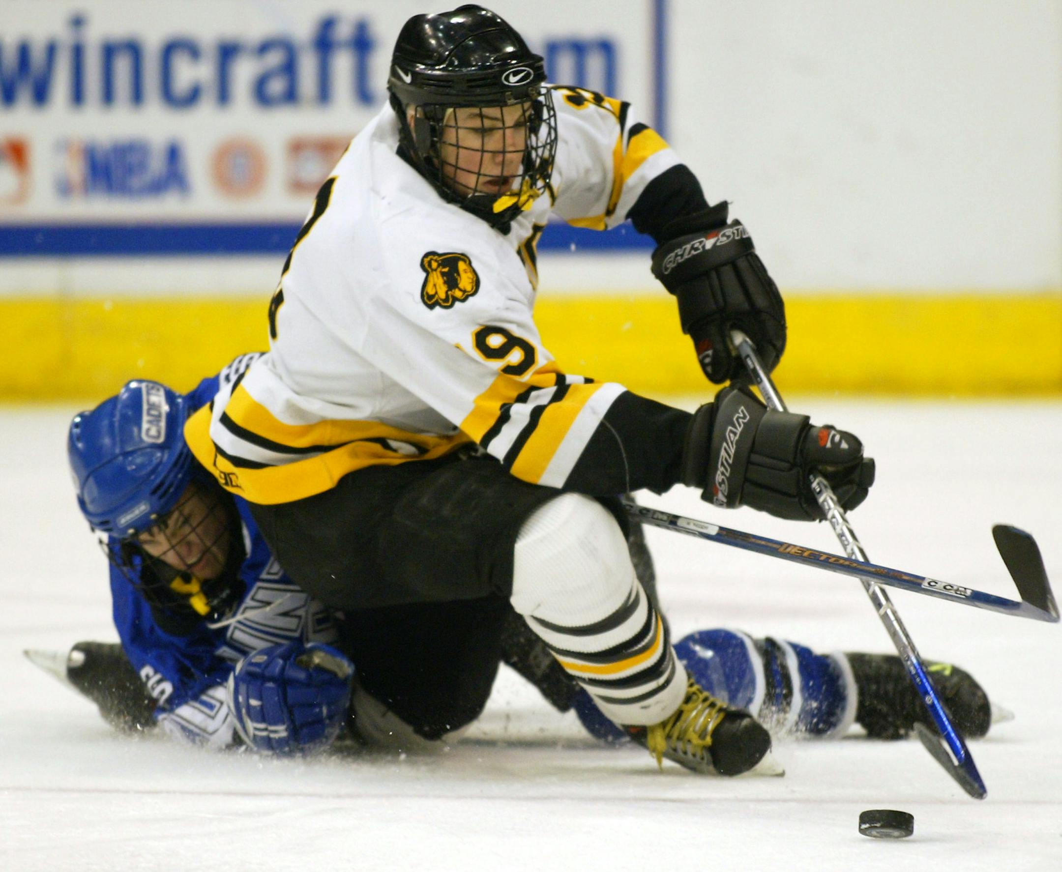 Bruce Bisping/Star Tribune. St. Paul, MN,. Friday, 3/4/2004. St. Thomas Academy vs. Warroad. (left to right) St. Thomas Academy's Dillon Donovan and Warroad's T.J. Oshie battled for a loose puck in first period action.