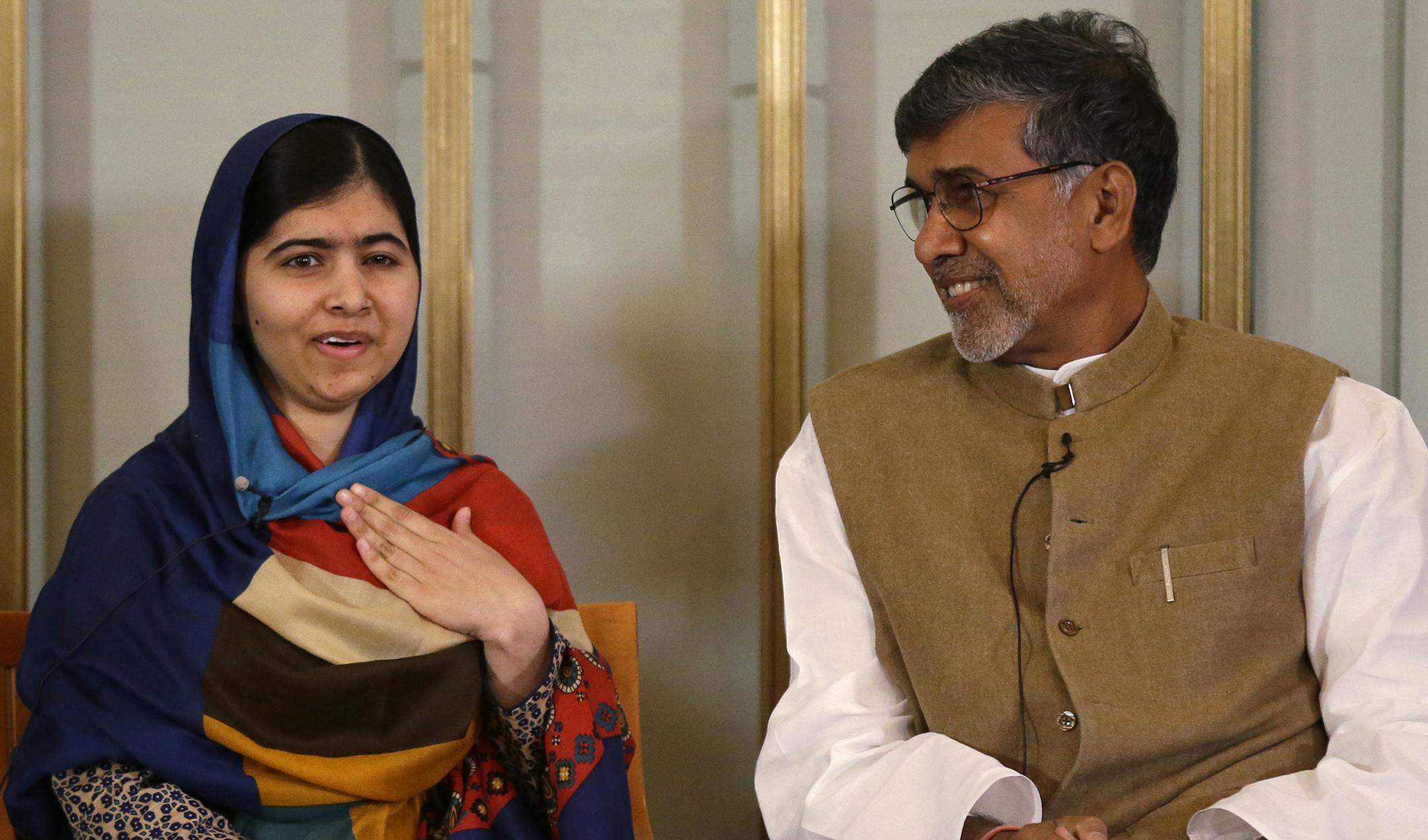 Joint-Nobel Peace prize winners Malala Yousafzai, left, and Kailash Satyarthi attend a press conference in Oslo, Norway, Tuesday, Dec. 9, 2014. The Nobel Peace Prize will be presented to and shared between the youngest Nobel Prize winner ever, 17-year-old Taliban attack survivor Malala Yousafzai and Indian children's rights activist Kailash Satyarthi in a ceremony in Oslo on Wednesday. (AP Photo/Matt Dunham) ORG XMIT: MIN2014120911214734