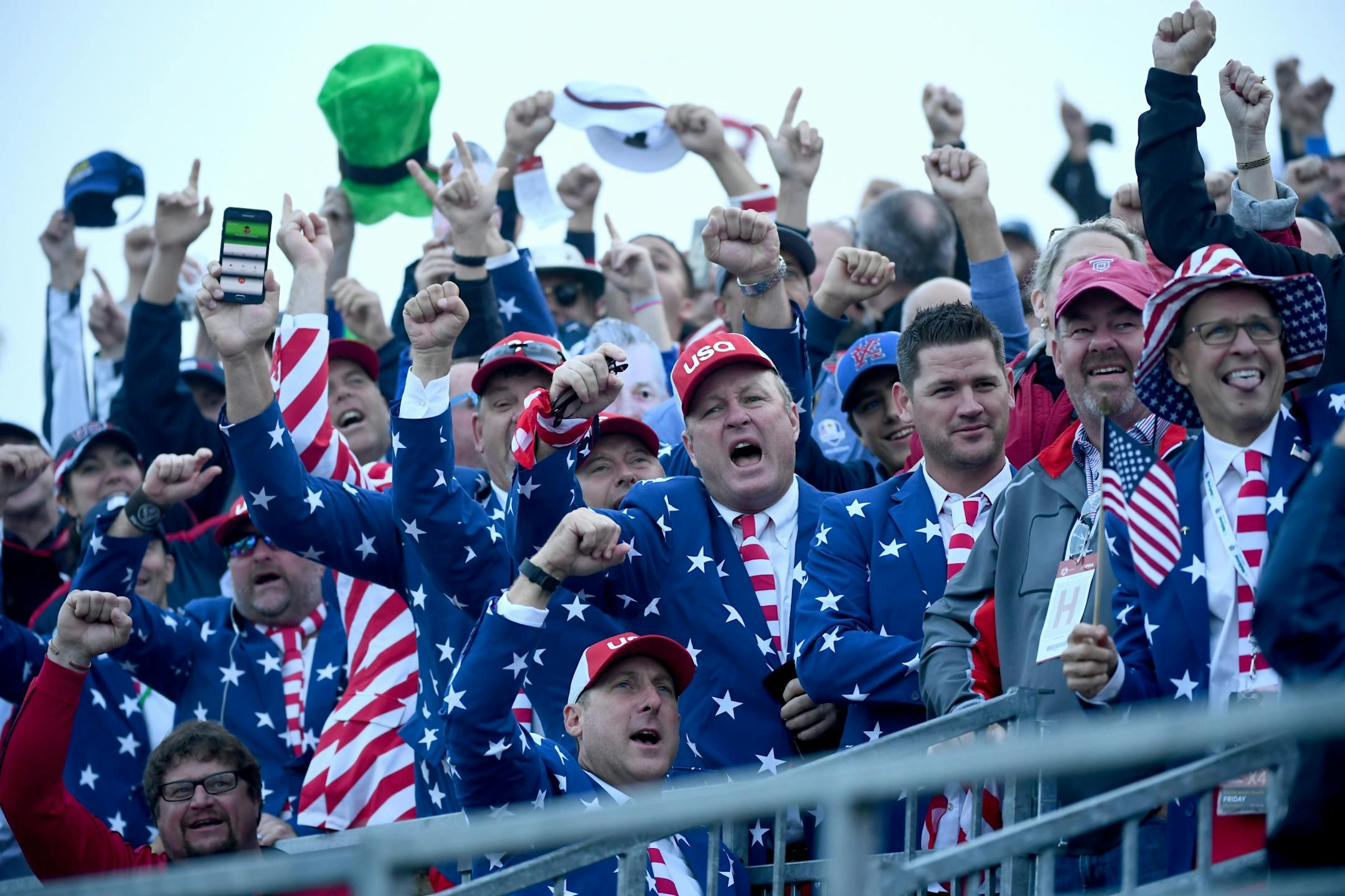 Fans celebrated at the first green early Friday morning as the first foursomes teed off in the Ryder Cup at Hazeltine in Chaska.