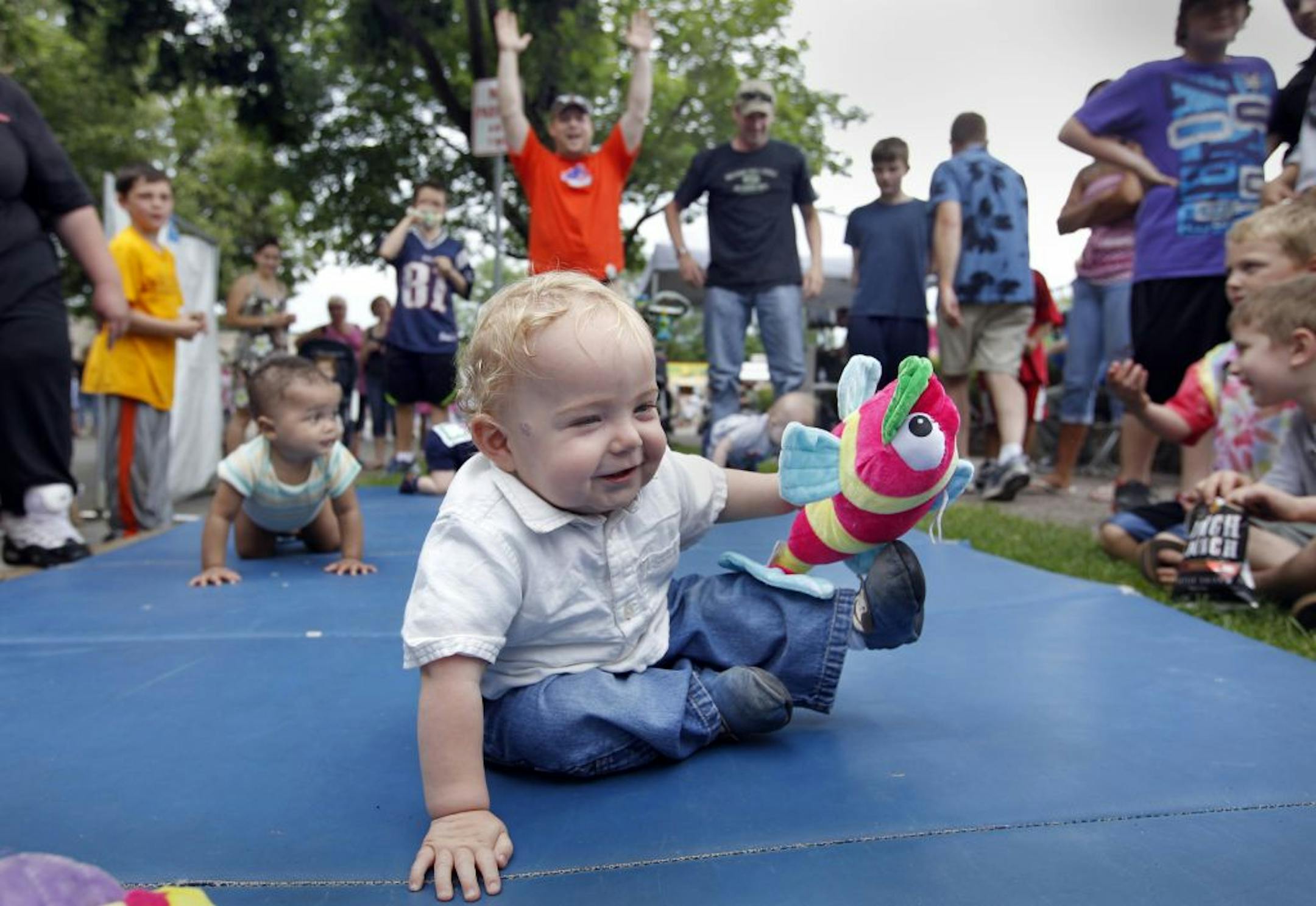 Nathaniel Longen, 11 months old, celebrated his win in the baby race at South St. Paul's Kaposia Days festival. The event commemorates the area's settlement by Kaposia Indians