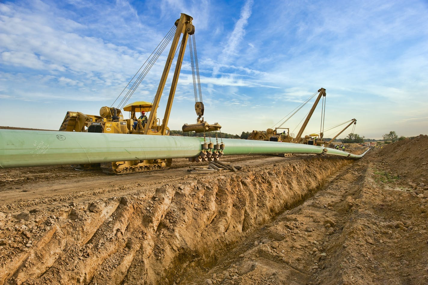 A crew installs a section of a crude oil pipeline for Enbridge Energy. The environmental impact statement is out for another of the Calgary-based pipeline company's projects, a replacement for Line 3 in northern Minnesota.