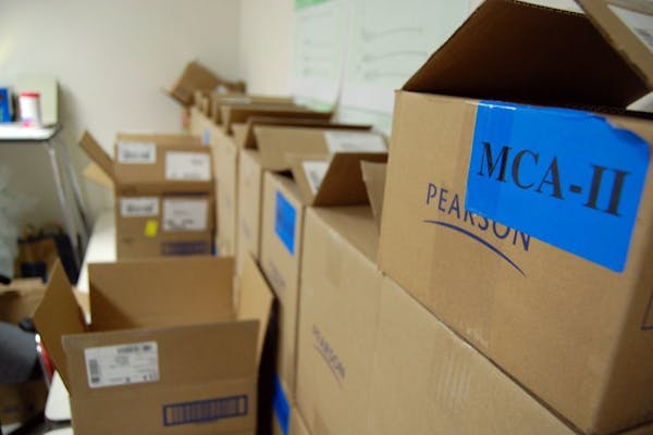 In this April 9, 2010 photo, boxes of MCA tests sit in a locked room at Richfield Middle School, Minn.