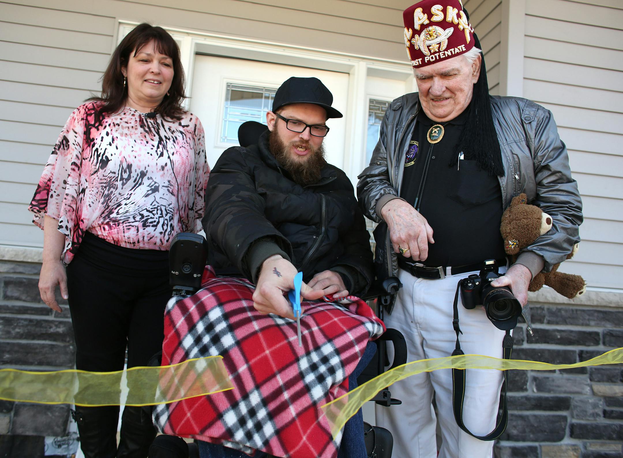 Zach Mohs cut the ribbon on his new home, which was built with a lot of donations.