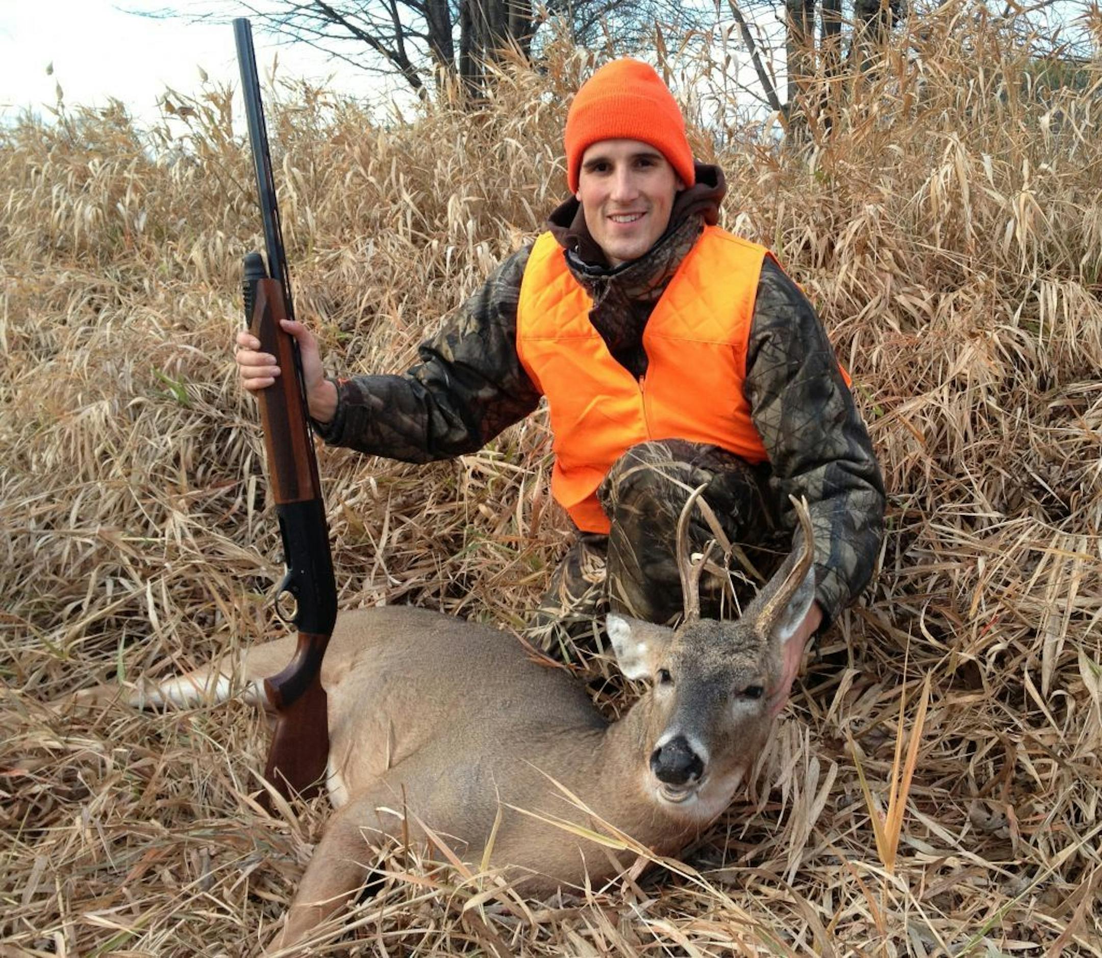 Simon Heuer of Burbank, Calif., formerly of Fairmont, Minn., with a deer he shot on a short visit home.