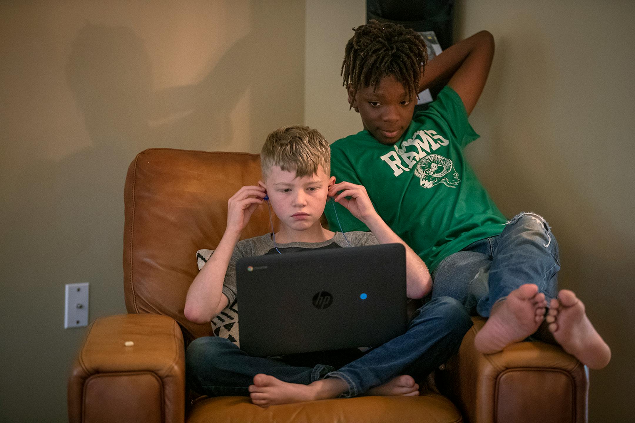 Brothers Ridge, 9, and Nelson Lundquist, 11, worked on school work, Tuesday, September 29, 2020 in Brooklyn Park, MN.