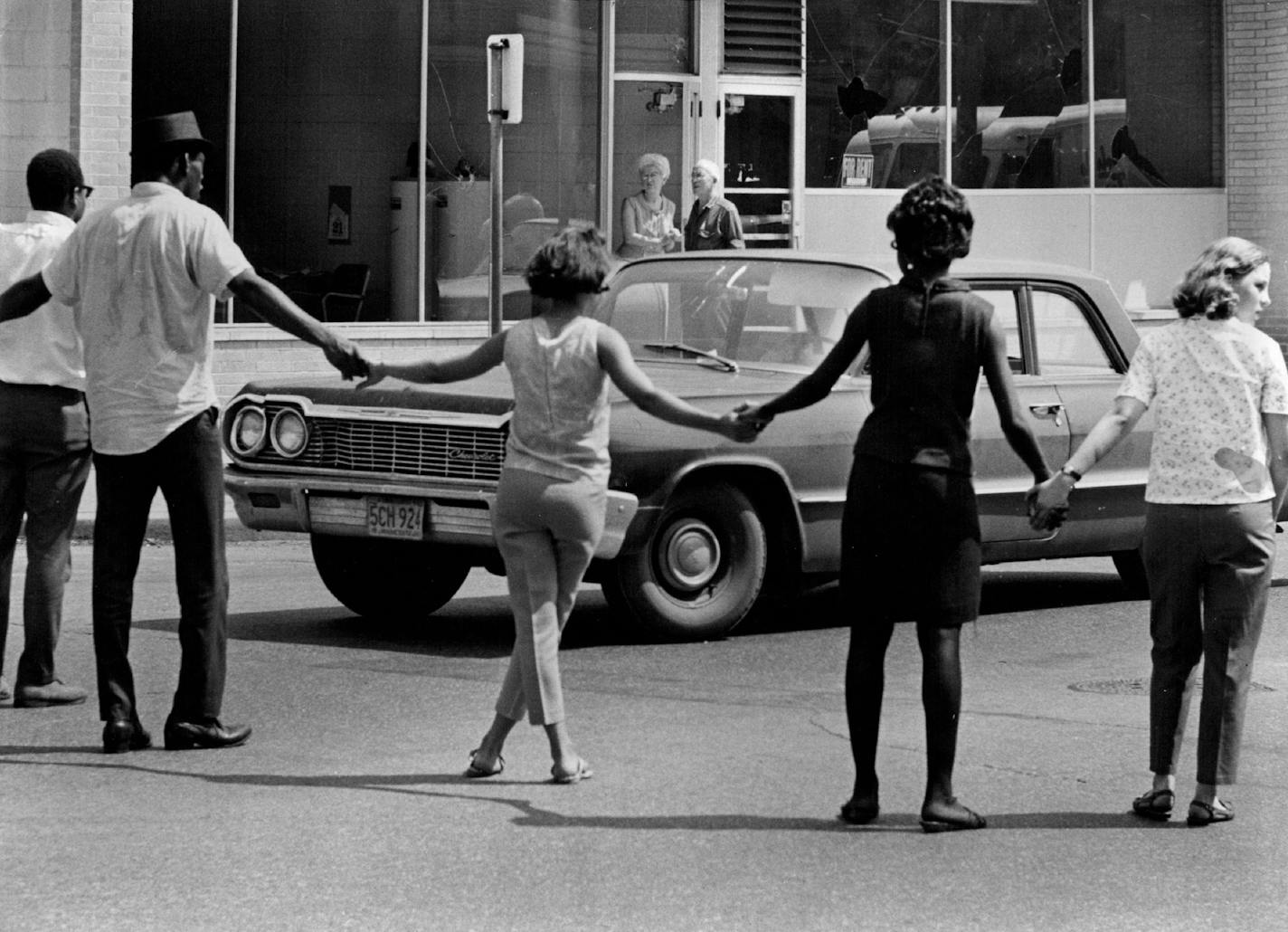 July 22, 1967 People From the Way Community Center Formed A Human Barricade To Keep Sightseers Away. The Kids get excited and want to throw rocks at them when they drive by a volunteer explained. The Way staff memoers stationed people at Plymouth Av. intersection from James Av. on the east and at Morgan Av. on the west to , keep sightseers away. "The kids get excited and want to throw rocks at them when they drive by," said Leonard Weaver, a Way volunteer. There was a near incident at 2:45 p.m.