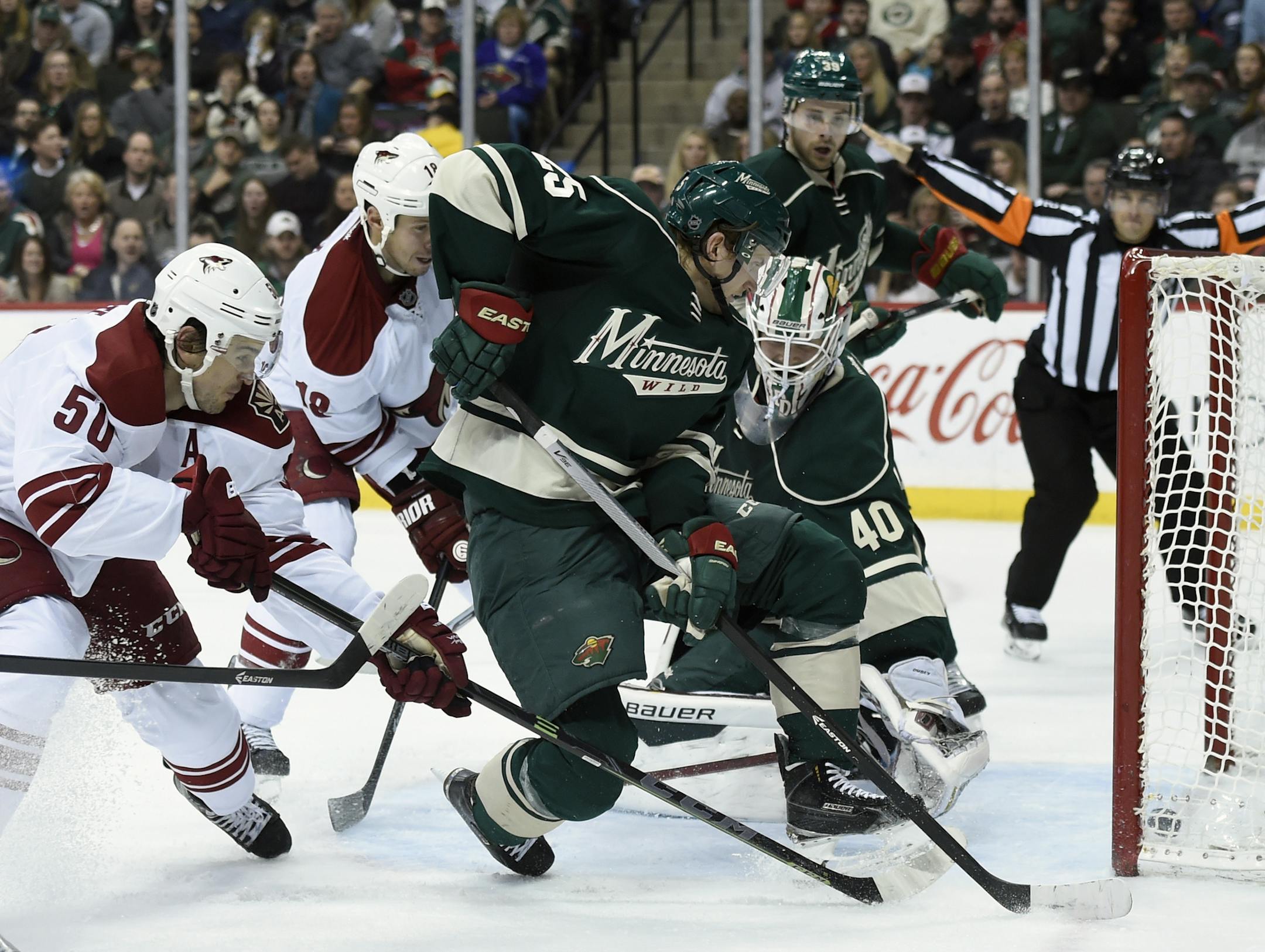 Arizona Coyotes center Antoine Vermette (50) scores a goal past Minnesota Wild defenseman Jonas Brodin (25) and goalie Devan Dubnyk (40) during the second period of an NHL hockey game Saturday, Jan. 17, 2015, in St. Paul, Minn. (AP Photo/Hannah Foslien)