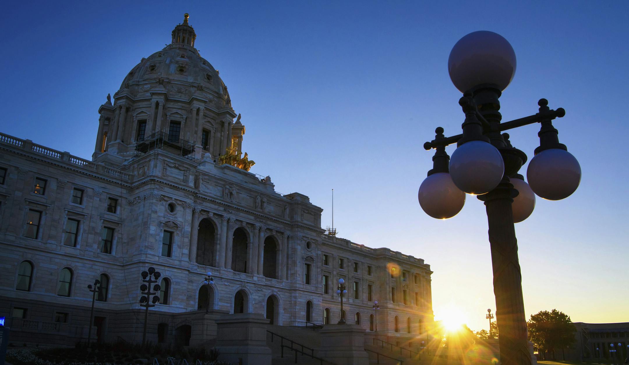 FILE - In this May 24, 2017, file photo, sun rises behind the Minnesota State Capitol in St. Paul, Minn. Minnesota lawmakers return to Capitol on Tuesday, Feb. 20, 2018, with a long list of work, and not much time to tackle it. The Legislature will discuss big-time tax code revisions, opioid abuse prevention efforts and possible constitutional amendments on the November ballot. (Glen Stubbe/Star Tribune via AP, File)