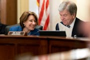 Senate Rules and Administration oversight Chair Sen. Amy Klobuchar, D-Minn., left, speaks with Sen. Roy Blunt, R-Mo., during a hearing to examine the 