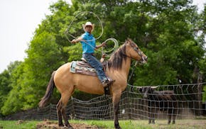 Turner Beachy, 17, practices his lassoing while riding, Ellie, a family friend’s horse that Beachy is training, at his friend’s farm in Ottertail,