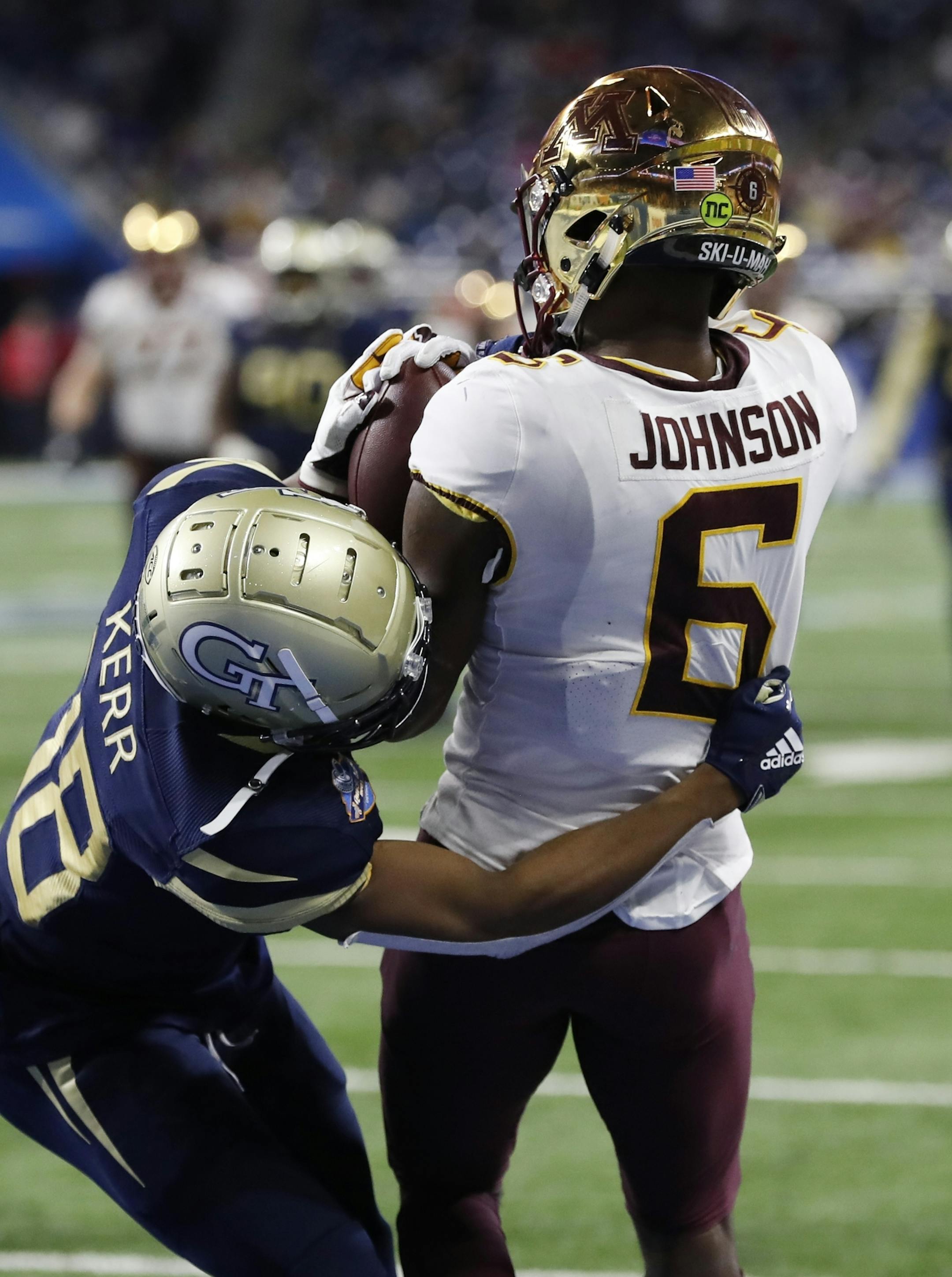 Minnesota wide receiver Tyler Johnson (6), defended by Georgia Tech defensive back Ajani Kerr (38), catches a pass for a touchdown during the second half of the Quick Lane Bowl NCAA college football game, Wednesday, Dec. 26, 2018, in Detroit. (AP Photo/Carlos Osorio)