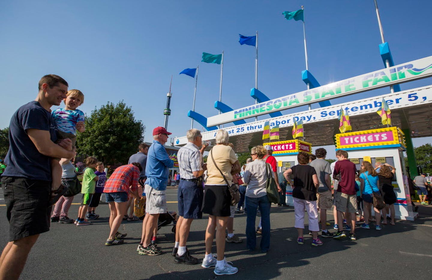 People line up at the main ticket booth on the first day of the State Fair in 2016.